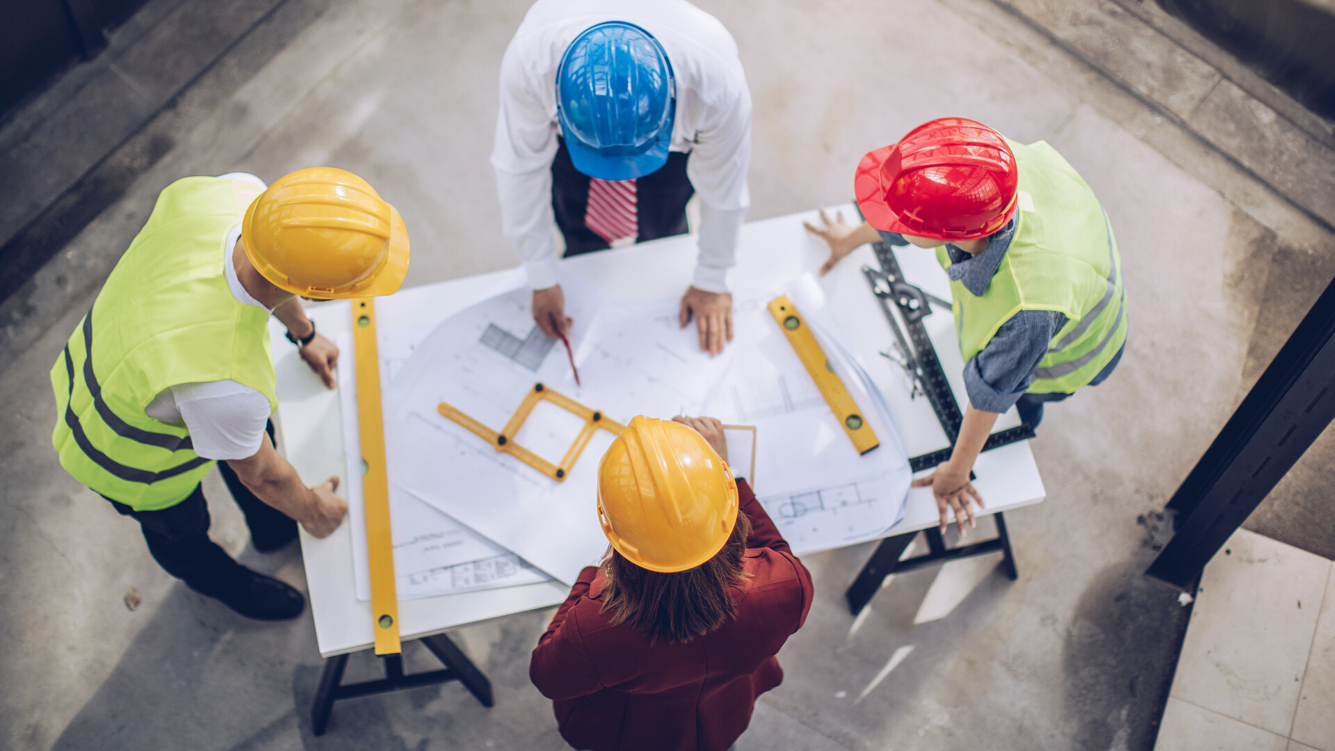 Architects working together at a construction site. Building codes and standards in North America.